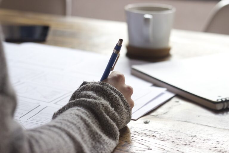 Person writing notes on a form
